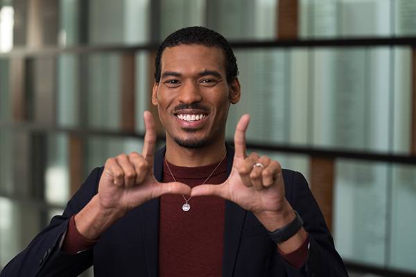 Dr. Bryan Hubain making a "U" with his hands