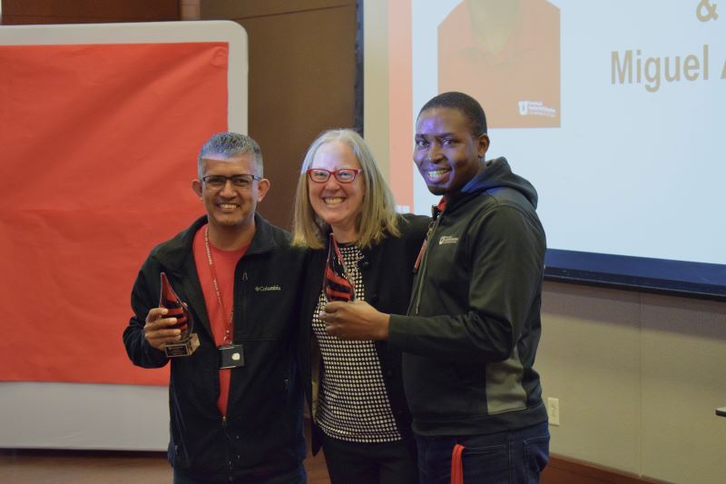 VP Mcdonald poses for photo with two HRE award winners holding their awards.