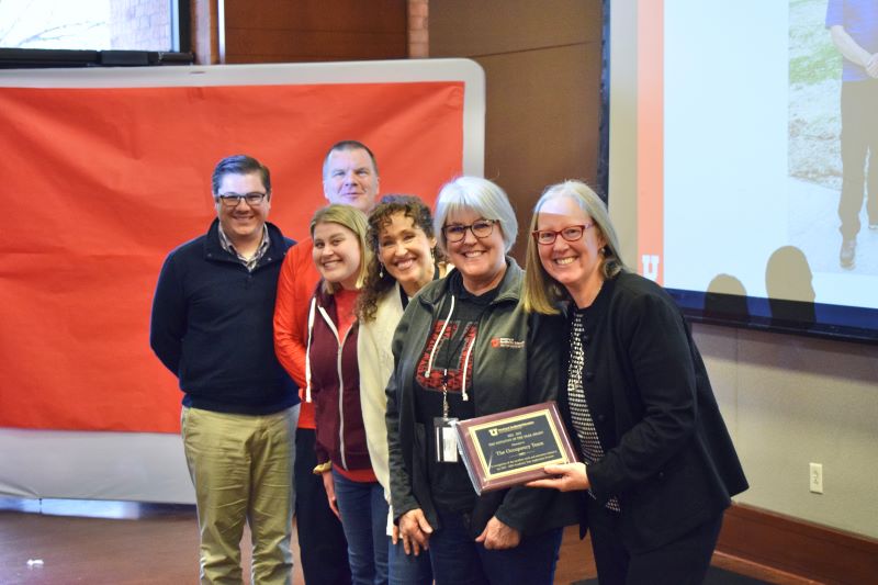 VP Lori McDonald poses for photo with group of HRE Award winners holding a plaque. 