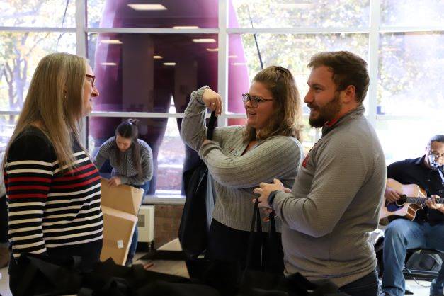 Lori McDonald talks to two student staff members at the Adapting to Student Needs Launch Party.