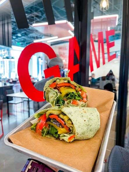 veggie wrap on a tray in front of window that says 