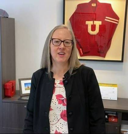 screenshot of a video of Lori McDonald speaking to the camera in her office with a red University of Utah sweater framed behind her.