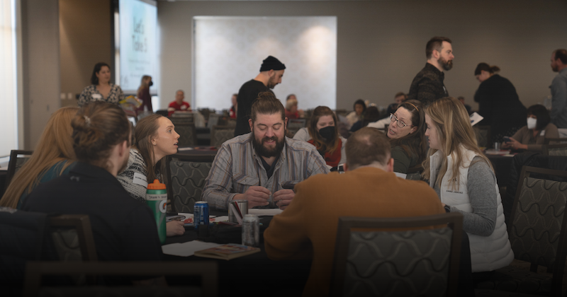 Students sitting around a table during a student-employee workshop. 